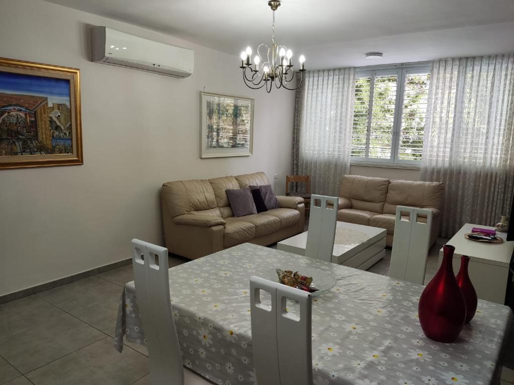 a living room with a table and a couch at Herzliya Center Apartments in Herzliya