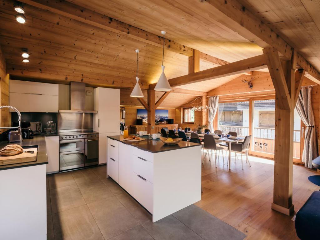 an open kitchen and living room with wooden ceilings at Chalet 4★, 15 pers, La Clusaz, sauna, centre village, 7 chambres - FR-1-304-177 in La Clusaz
