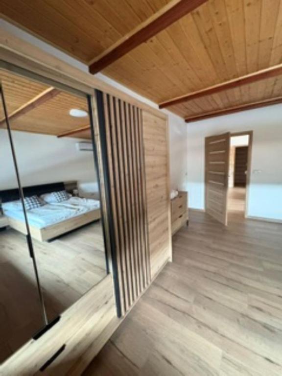 a room with two beds and a wooden ceiling at Apartament u Anitki in Trzebnica