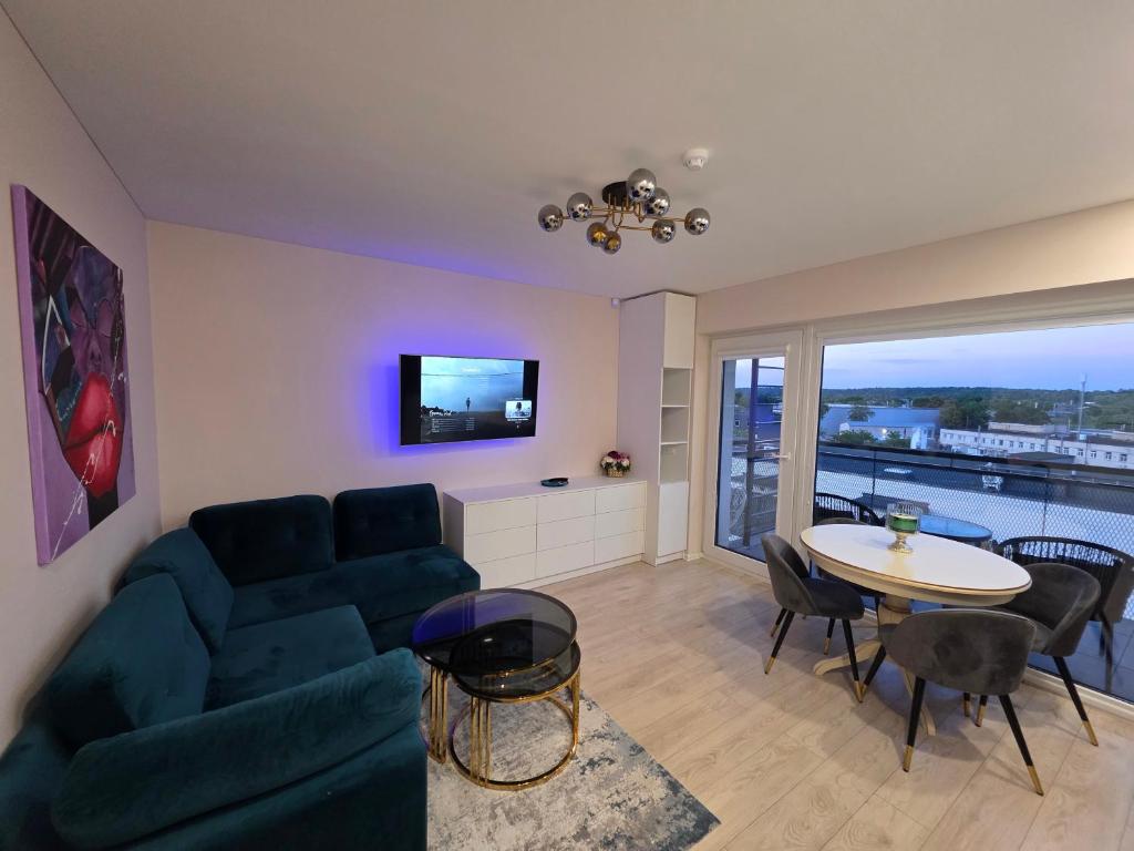 a living room with a couch and a table at Nemunas Riverside in Kaunas