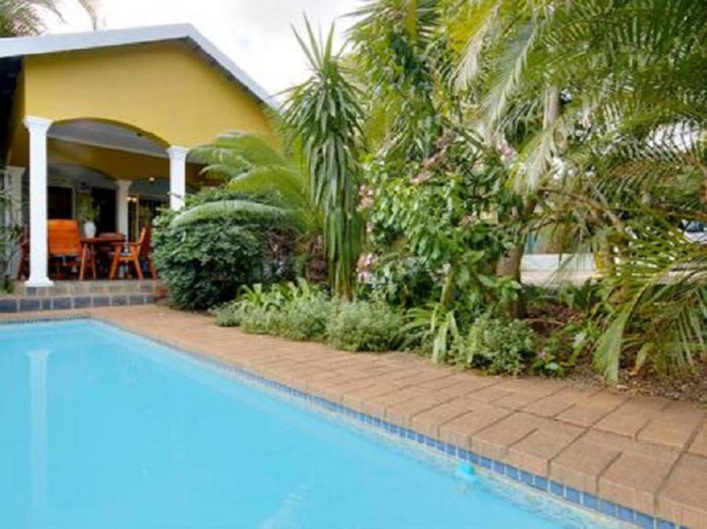 a swimming pool in front of a house at Raptor's Rest Bed and Breakfast in Empangeni