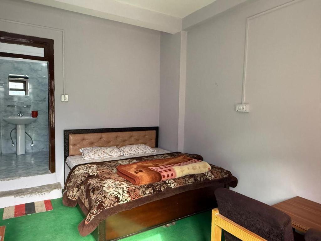 a bedroom with a bed and a sink at Rock View in Kulu