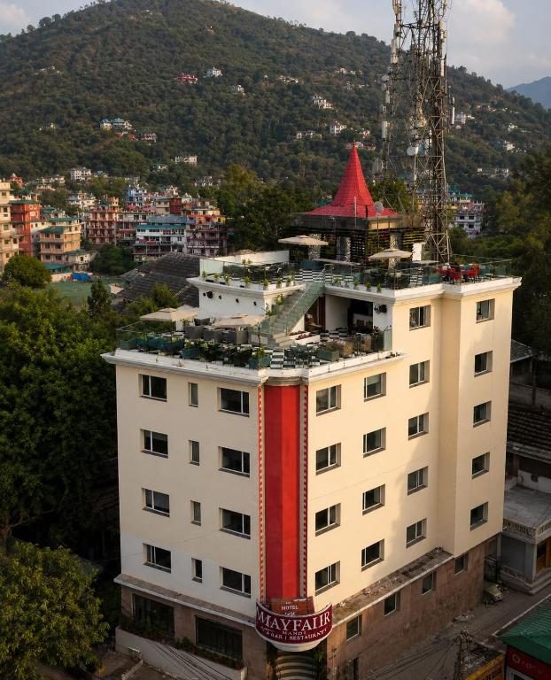 a white building with a red roof on top of it at May Fair in Mandi