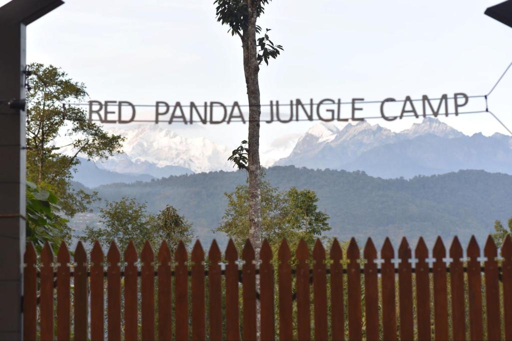 a fence with a view of the red panda jungle camp sign at Red Panda Jungle Camp - A Unit of Davinchi Homes Pvt Ltd in Gyalzing