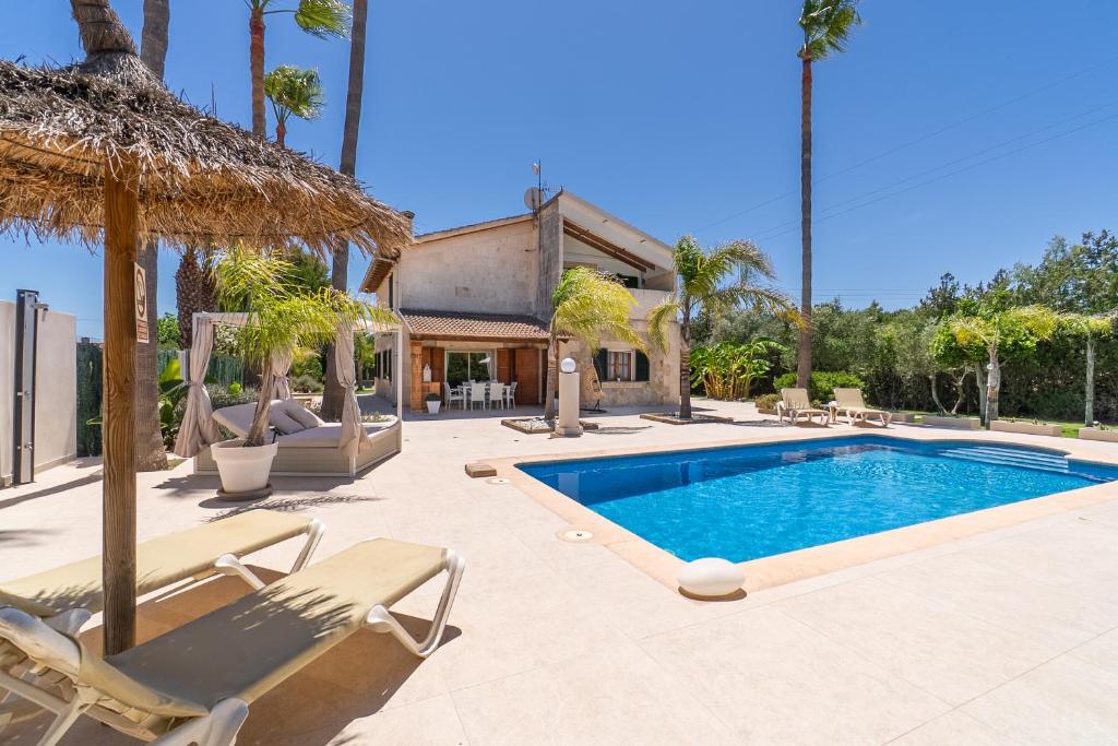 a swimming pool with chaise lounges and a resort at Villa Agueda in Muro