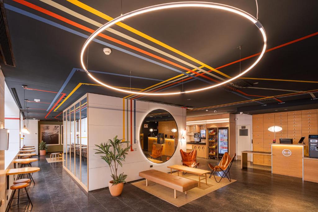 an office lobby with a circular light fixture at B&B HOTEL Castellón in Castellón de la Plana
