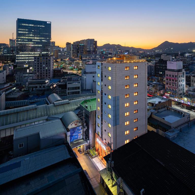 a view of a city at sunset with buildings at 스태이링크 Staylink in Seoul