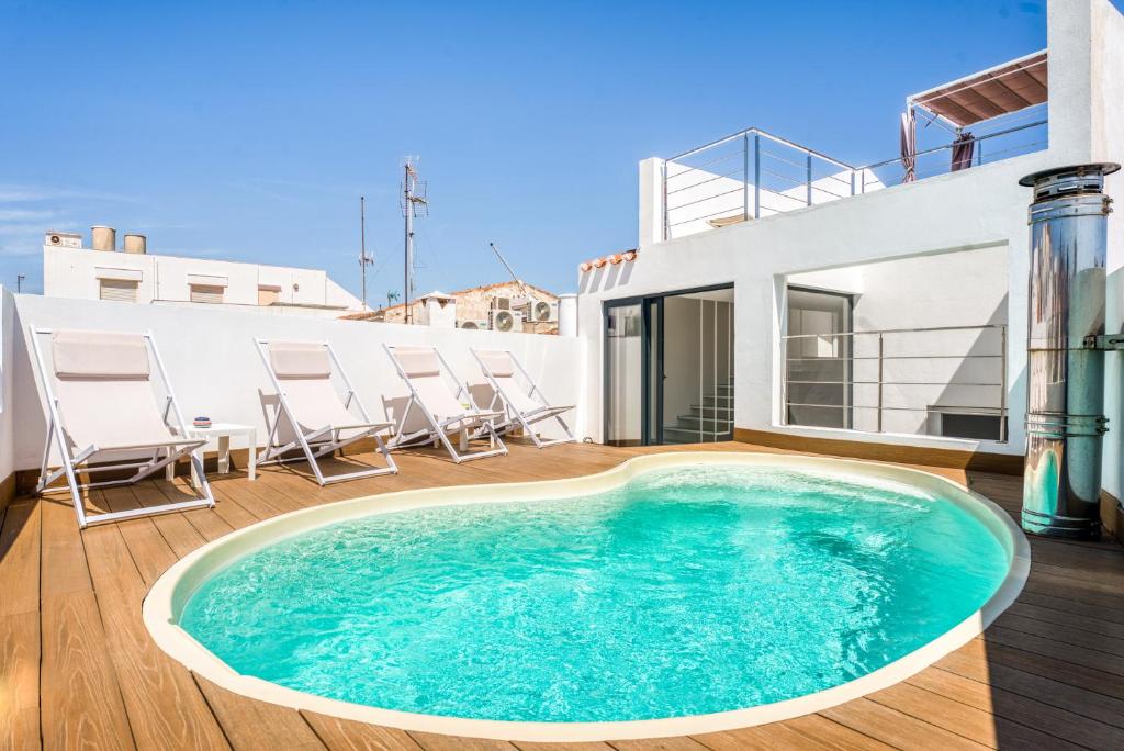 a swimming pool on the deck of a house at Casa S’Arraval in Mahón