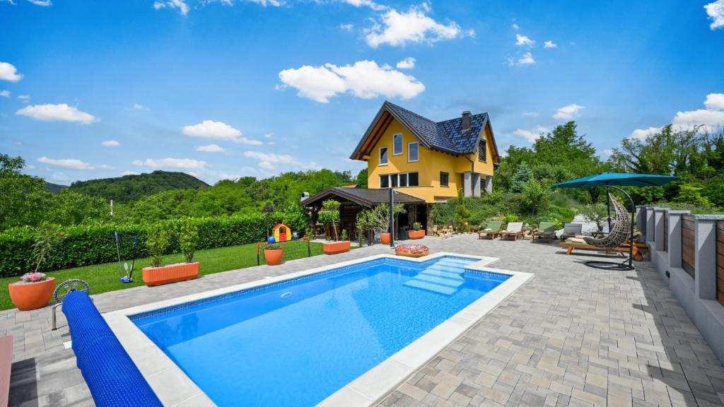 a home with a swimming pool and a house at Villa Exclusive by Villas Guide in Lepoglava