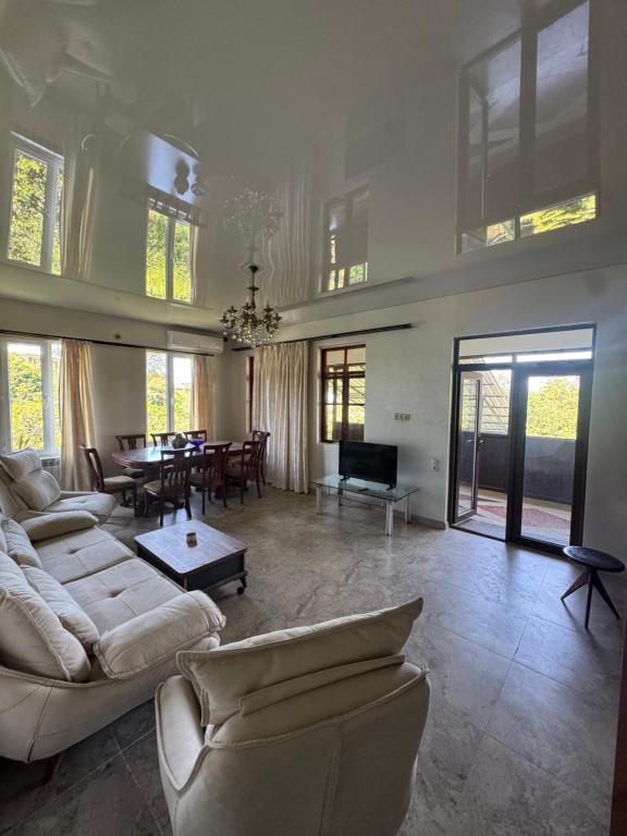 a large living room with couches and a dining room at Bato's Vacation House in Gonio