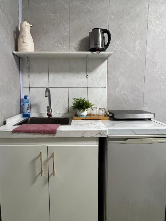 a kitchen with a sink and a counter top at Studio in Darhan