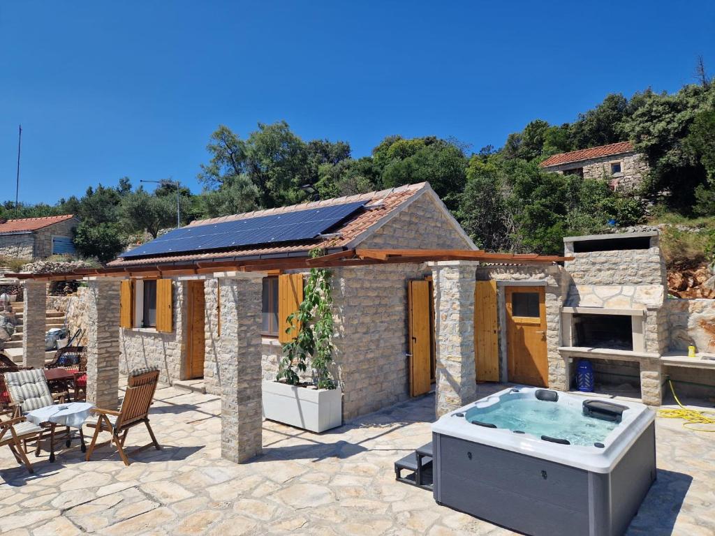 a house with a hot tub in a patio at Robinson Hideaway Korčula in Korčula