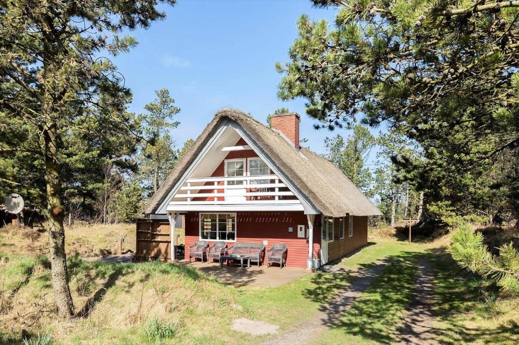 a large red house with a thatched roof at 0025-Romo-P-J-Manosvej-18 in Høm