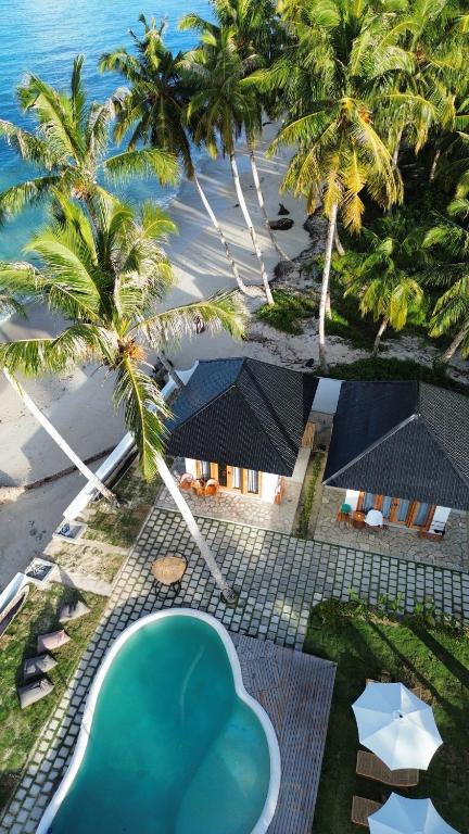 an aerial view of a resort with a swimming pool at Ombara Resort Mentawai in Katiet