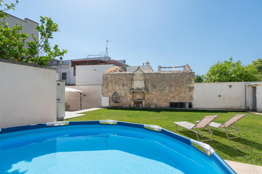 a swimming pool in the yard of a house at Al Vecchio Cinema Martano in Martano