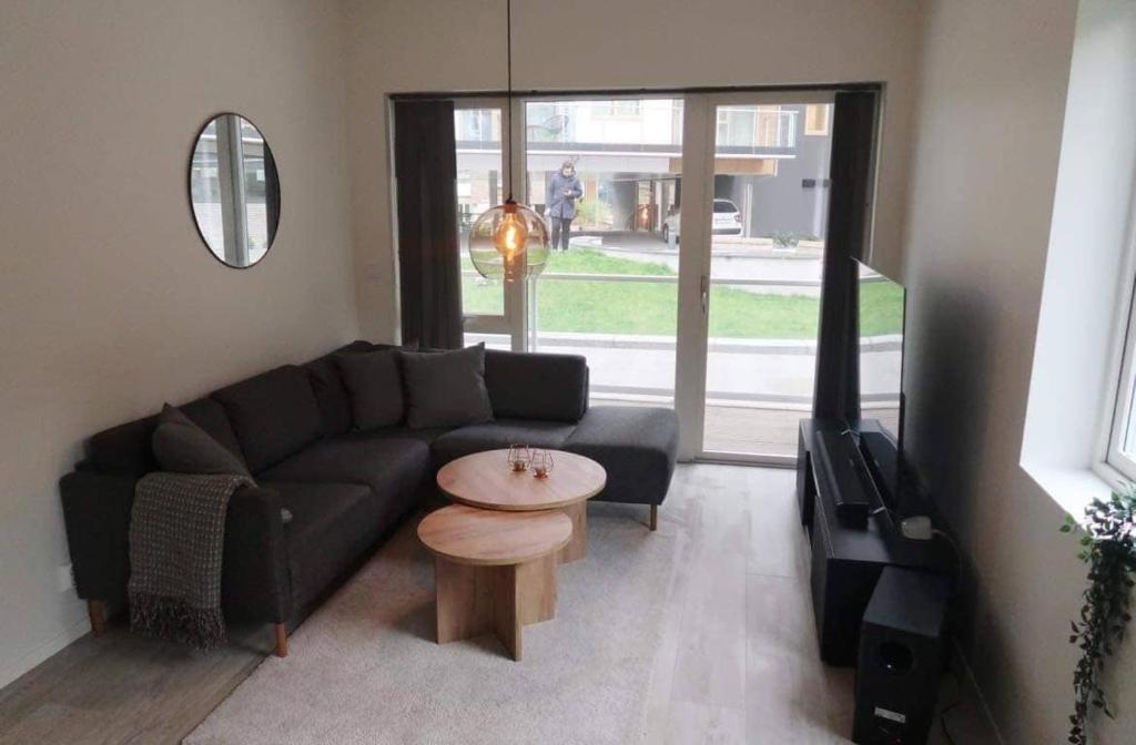 a living room with a black couch and a table at Modern Apartment Bergen Centrum in Bergen