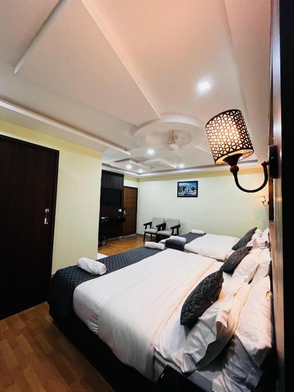 a bedroom with a large bed in a room at Hotel La Gowri, Coorg in Madikeri