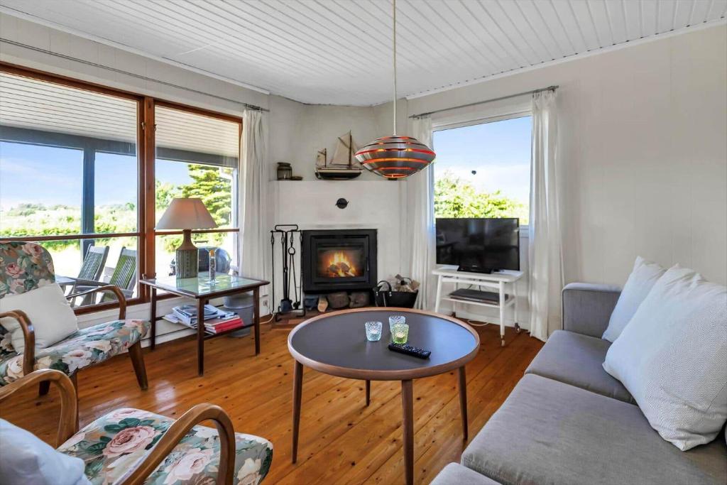 a living room with a couch and a fireplace at 16615-Farevejle-Alfestien-10 in Fårevejle