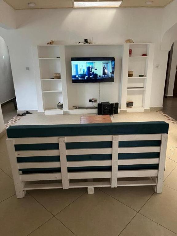 a room with a counter with a tv on top at Kilifi Hideaway,Spacious Coastal Retreat in Kilifi