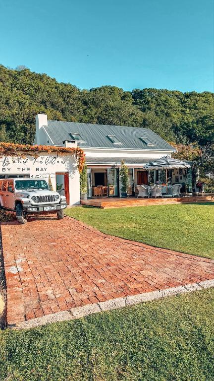 a truck parked in front of a house at Buff and Fellow by the Bay in Great Brak River