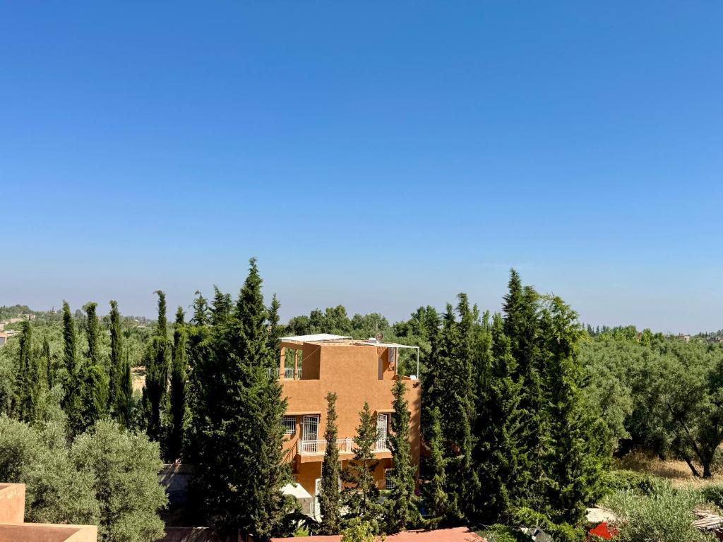 a house in the middle of a forest of trees at Atlas View Luxury Villa in Ourika