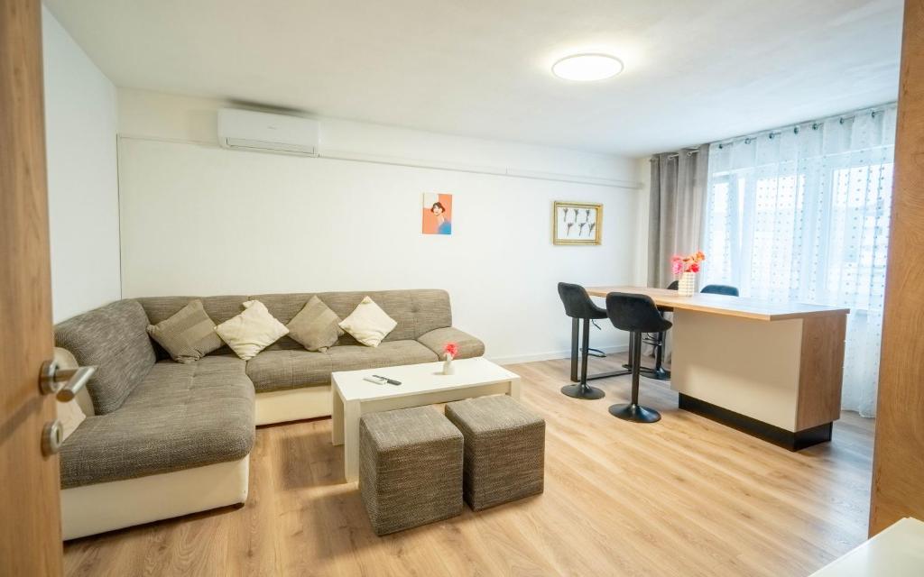a living room with a couch and a desk at Apartman Lili in Knin