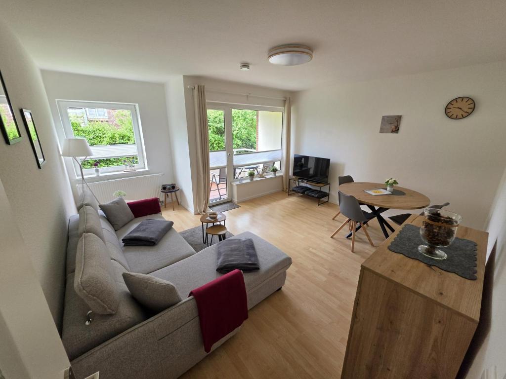 a living room with a couch and a table at FeWo Büsum No 12 in Büsum