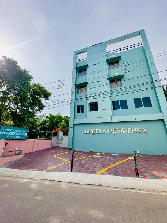 a building on the side of a street at Breeza Residency in Kazhakuttam