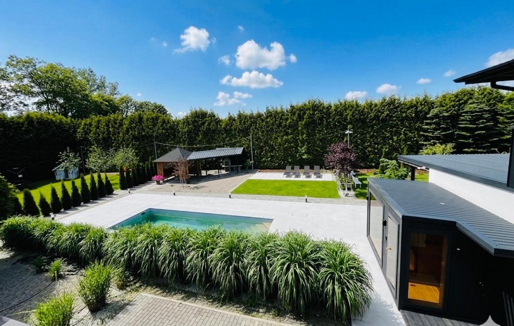 a backyard with a swimming pool and plants at Apartamenty Lumax in Gryfice