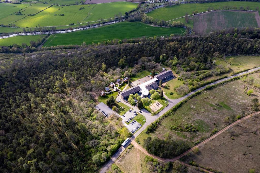 an aerial view of a house in a field at Mont-des-Pins in Durbuy