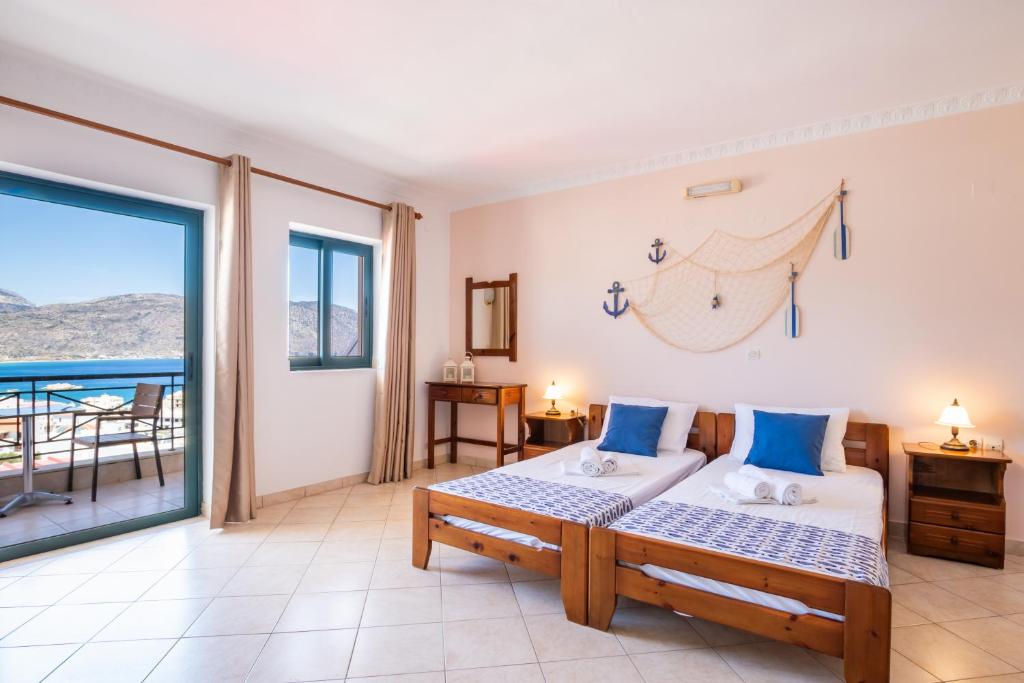 a bedroom with a bed and a balcony at Giota's Studio in Karpathos