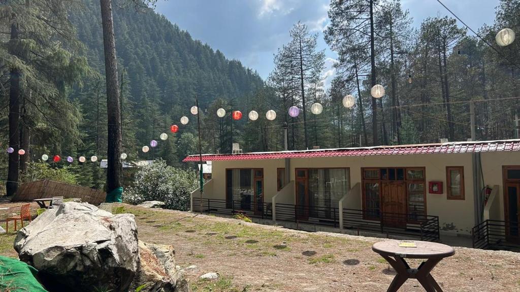 a small building with a table in front of it at Northbound Kasol in Kasol
