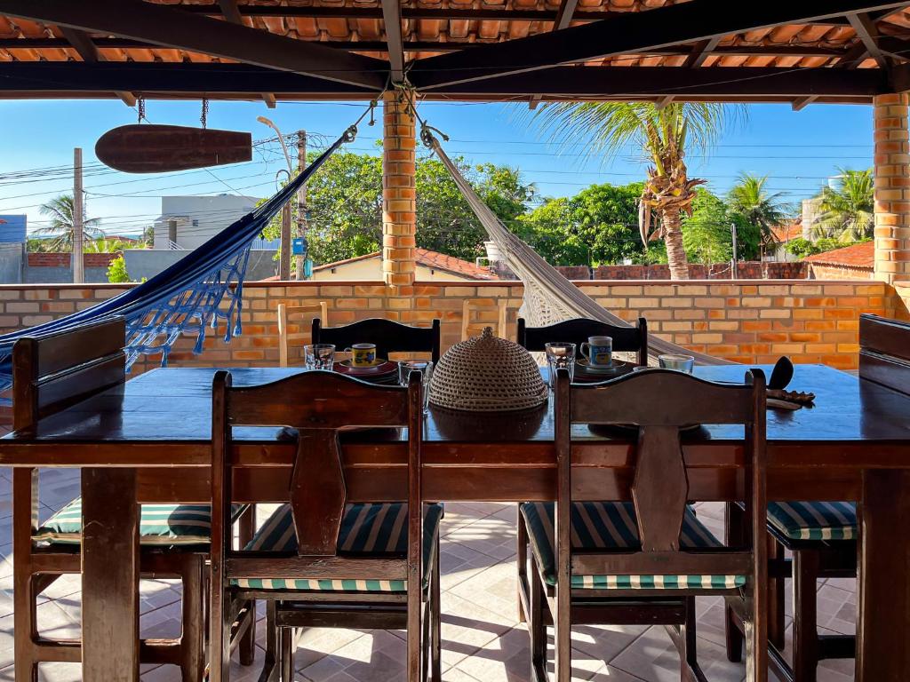 a table with chairs and a hat on a patio at Loft NOA'House in Canoa Quebrada