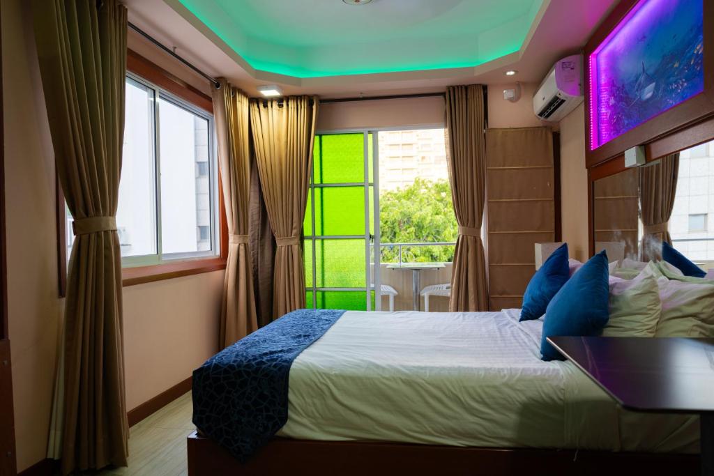 a bedroom with a large bed and a window at Six In Lodge in Male City