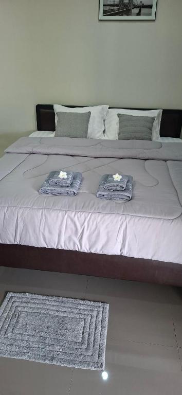 a bed with two towels on top of it at TR Hotel Udon Thani in Ban Dong Kheng