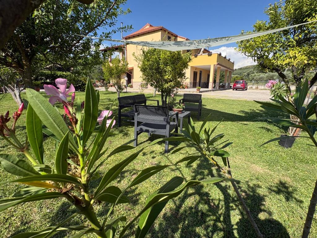 a park with benches and flowers in the grass at La casa di Nonna Anna in Castellabate