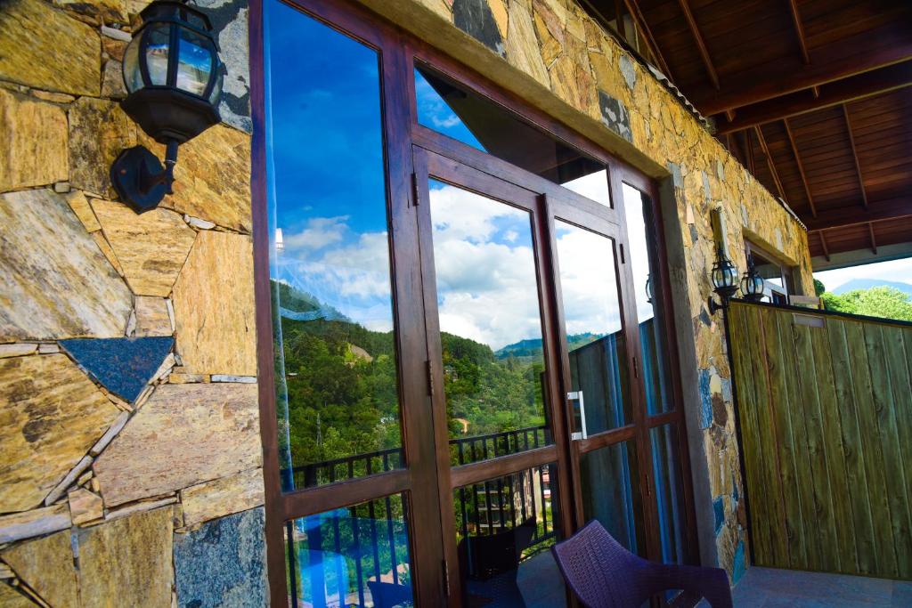 a window with a view of a mountain view at Ever Breeze Ella Hotel in Ella