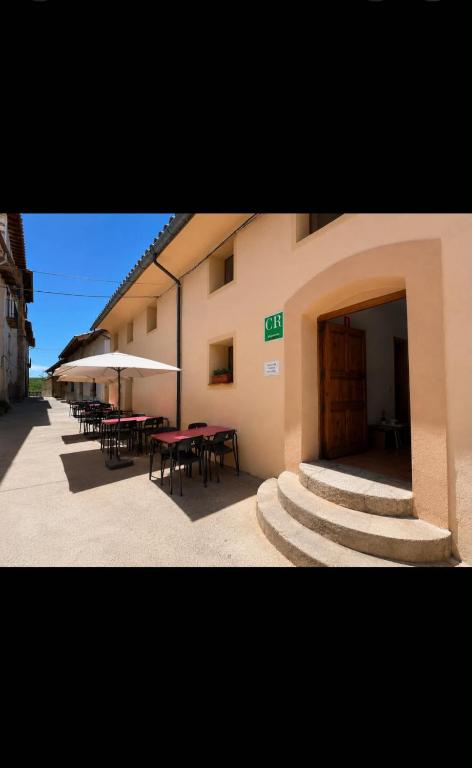 a building with tables and chairs and a patio at Casa Rural Tronchon in Tronchón