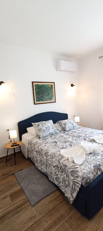 a bedroom with a large bed with two pillows at Villa Golden Coast - Lagos in Lagos
