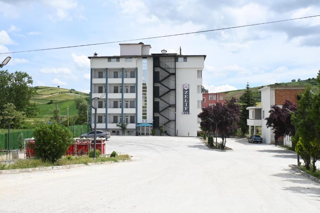 an empty parking lot in front of a building at Zelif Otel Havza in Havza