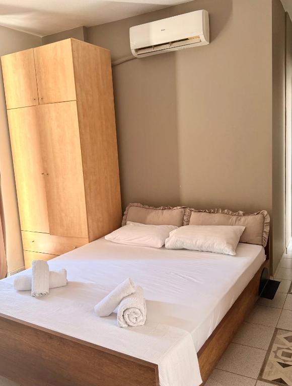 a bed with towels on it in a room at Alpha apartment 21 in Serres