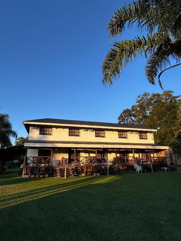 a building with tables and chairs in a park at Cabañas del Paraiso in Colón