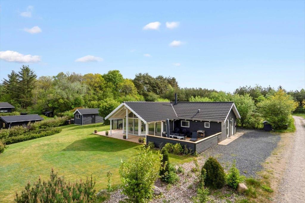 a house in the middle of a yard at LF15028-Skals-Lynderup-Strand-6 in Skals