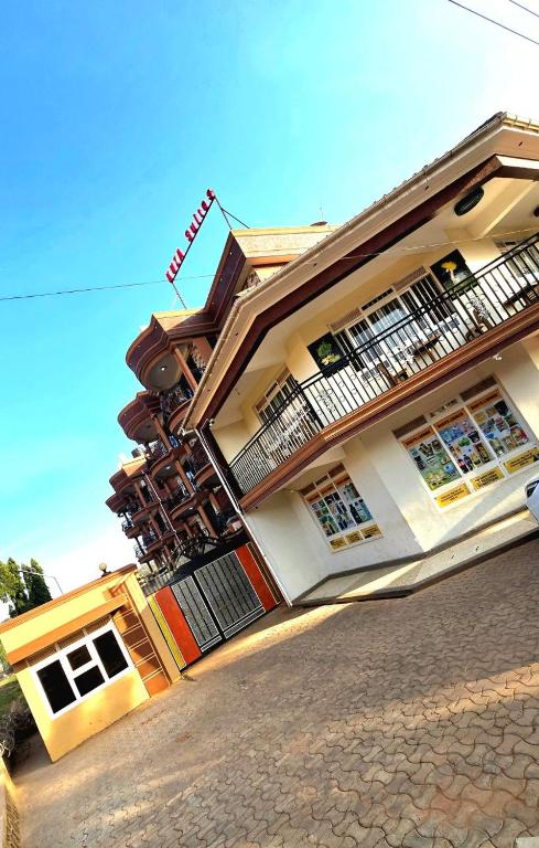 a large building with a fire escape on a street at kuza Suites Mbale in Mbale