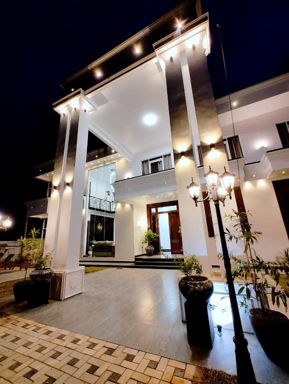 a large white building with lights on it at Panorama Safari Villa in Trincomalee