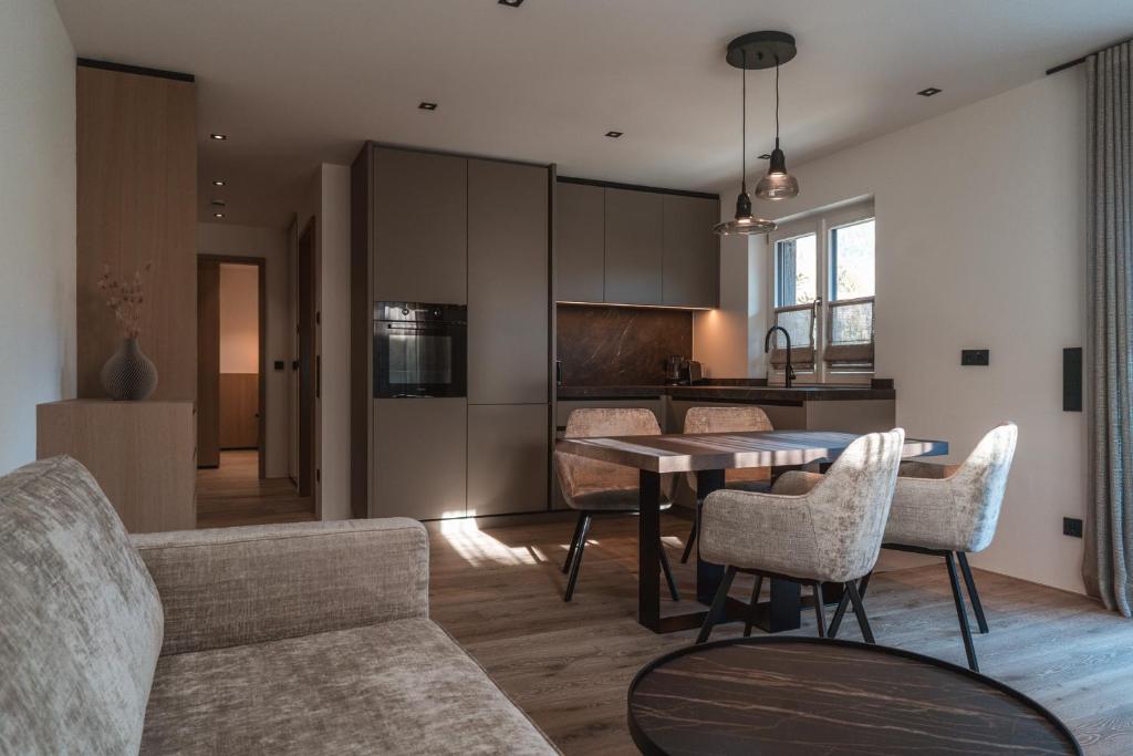 a kitchen and living room with a table and chairs at Egerner Chalet in Rottach-Egern