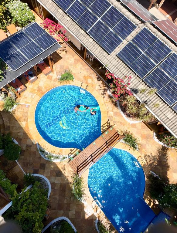an overhead view of a swimming pool with solar panels at Pousada Windjeri in Jericoacoara