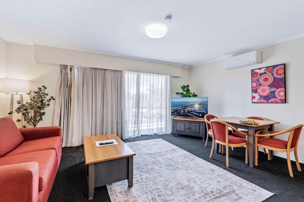 a living room with a couch and a table at Charming Suite Easy Access 2 CBD by Custom Bnb Hosting in Brisbane