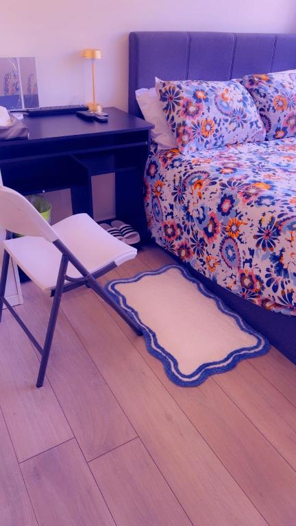 a bedroom with a desk and a chair next to a bed at 32 Hatton Guest House in Milton Keynes