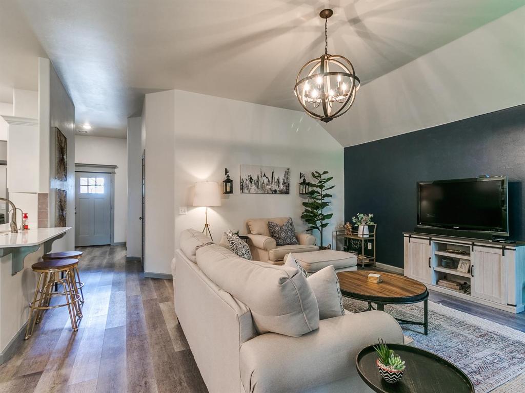 a living room with a couch and a tv at Your Unforgettable Temporary Haven! in Edmond